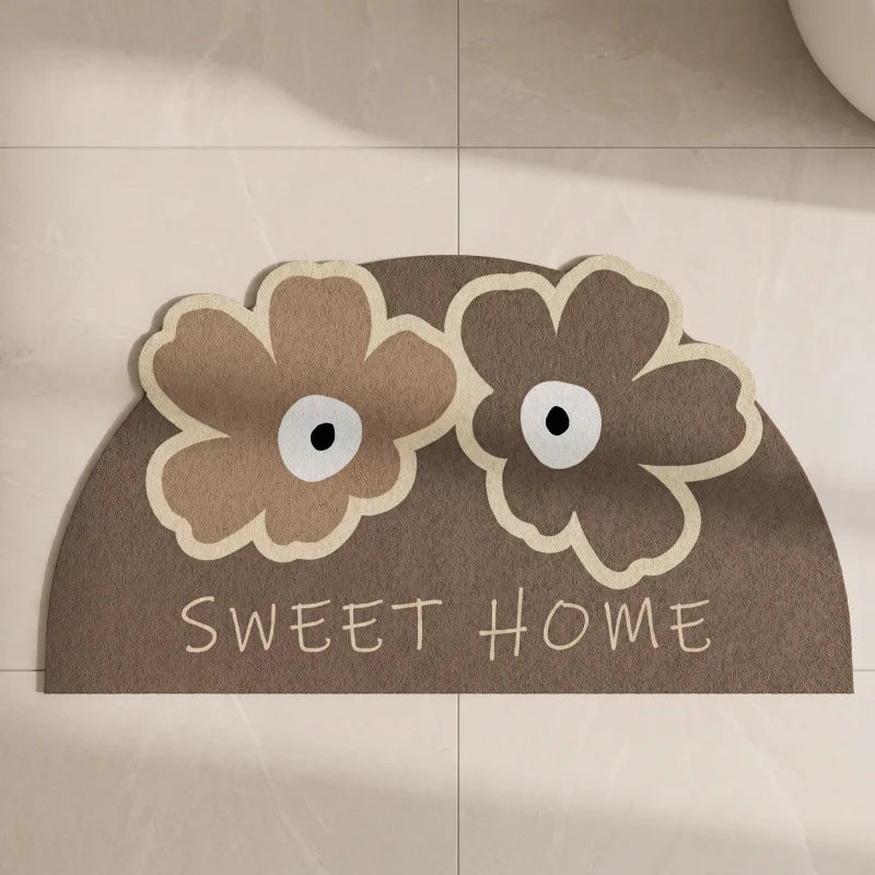 tapis de bain demi lune marron en diatomite avec motifs fleurs sweet home devant une douche