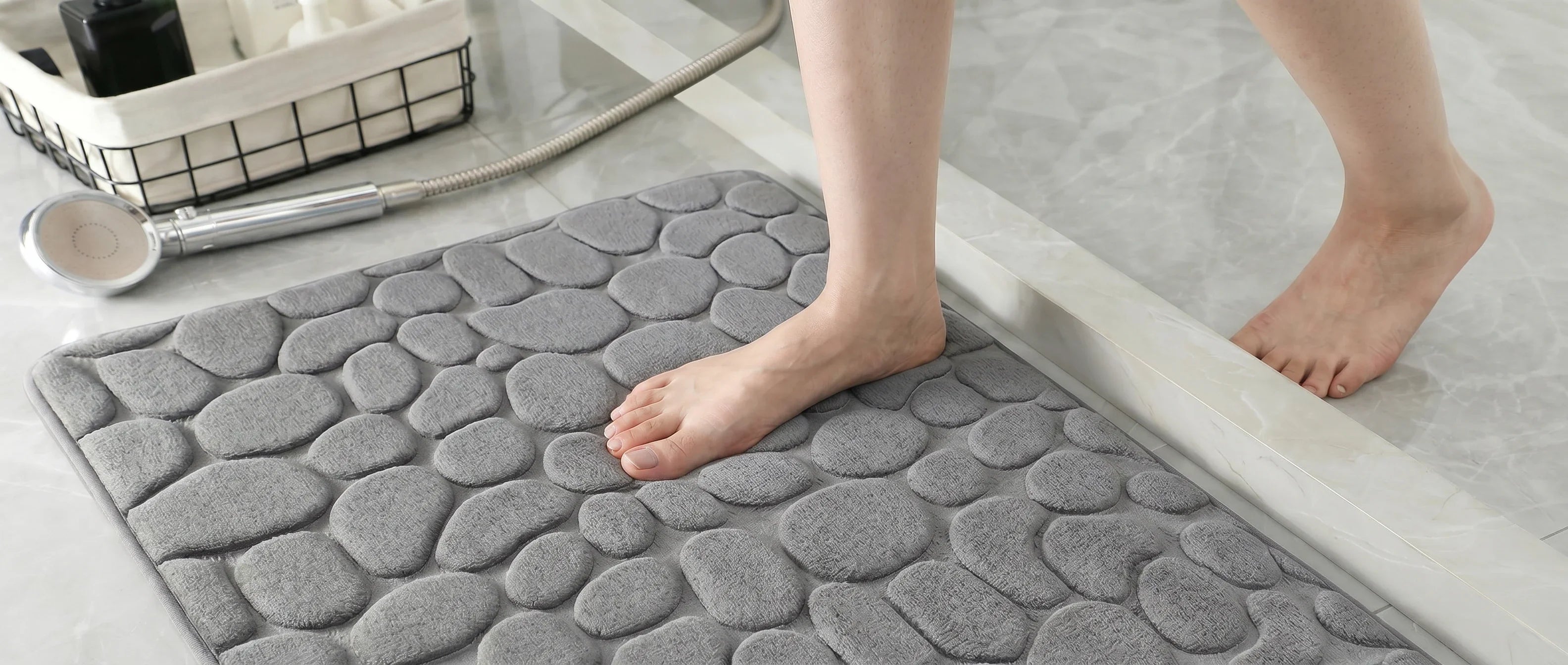 Tapis de bain antidérapant, posé au sol d'une salle de bain premium en marbre gris